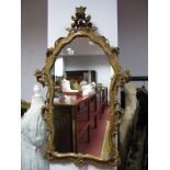 A Mid to Late XX Century Continental Shaped Wall Mirror, in wooden scrollwork frame, 110 x 67cm.