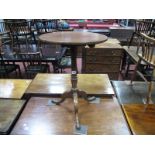 An XVIII Century Mahogany Pedestal Table, with circular top, turned pedestal on cabriole legs with