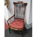 A Late XIX Century Ash Nursing Chair, with a cross rail back, shaped arms, caned seat, on turned