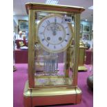 A Late XIX Century Gilt Metal Rectangular Mantel Clock, with bevelled glass sides and shaped base,