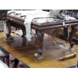 A XIX Century Mahogany Framed Footstool, with floral needlework upholstered top, cushion shaped