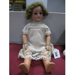 An Early to Mid XX Century Simon Halbig Bisque Headed Doll, stamped "SH/5600", with sleepy eyes,