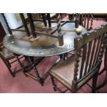 An Early XX Century Oak Drop Leaf Dining Table, with semi circular carved leaf decoration to oval