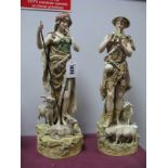 A Pair of Royal Dux Figures of a Shepherd and Shepherdess, she holding a staff with goats at her