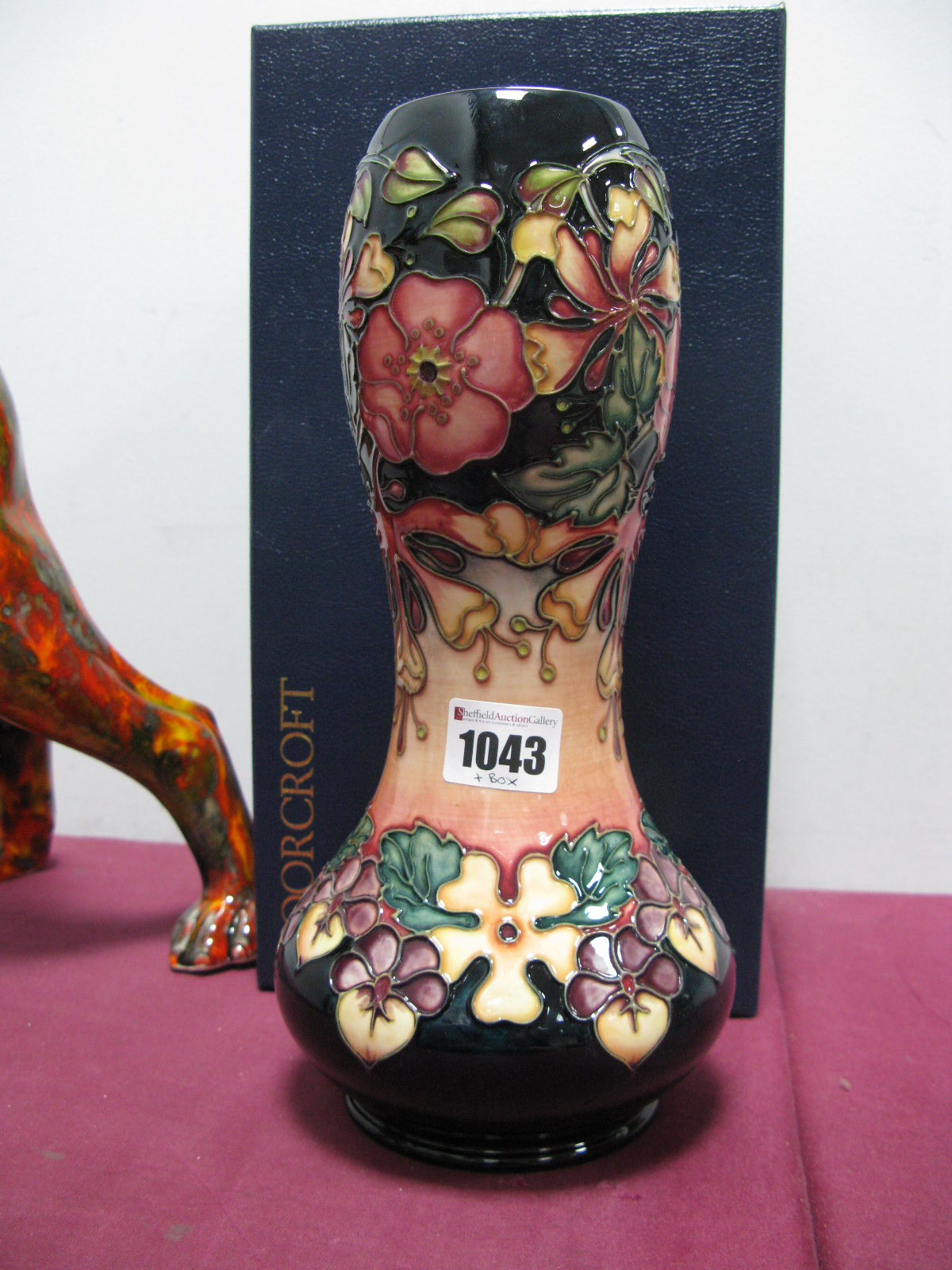 A Moorcroft Pottery Vase, of waisted baluster form, painted in the 'Honeysuckle' pattern against a