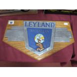 A Mid XX Century Leyland Atlantean Badge, presented on a wooden plinth.