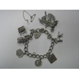 A Curb Link Charm Bracelet, to heart shape padlock style clasp, suspending novelty charm pendants