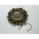 A XIX Century Mourning Style Brooch, of shaped oval design with glazed panel enclosing hair, the