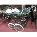 A Mid XX Century Silver Cross Pram, with green body work and assorted lace interior.