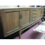 A 1960's G Plan Style Teak Sideboard, with twin panelled doors, four central drawers, 213 cm wide