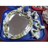 A German Pottery Heart Shaped Wall Mirror, with wing cherub cresting, three candle branches and