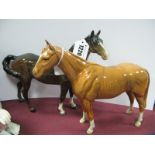 A Beswick Palomino Horse, 21.5cm high, together with one other Beswick horse (damaged). (2)