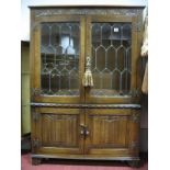 A XX Century Oak Display Cabinet, with leaded glazed doors, linenfold cupboard doors, on bracket