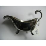 A Hallmarked Silver Sauce Boat, JEB, Sheffield 1948, with leaf capped flying scroll handle, raised