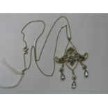 An Edwardian Openwork Seed Pearl Set Pendant, of scroll design, with triple collet set drops,