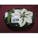 Moorcroft 'Bermuda Lily' Pattern Oval Shaped Trinket Box, with paper label "By Appointment, W.