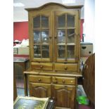 A Pine Kitchen Display Cabinet, with upper glazed doors over four drawers and cupboards.