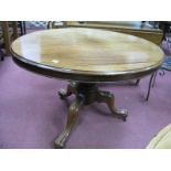 A XIX Century Mahogany Oval Shaped Loo Table, top with a moulded edge, turned pedestal table, on