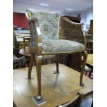 A 1920's Bergere Chair, with upholsted back and seat, caned side panels on cabriole legs.