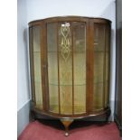 A Mid XX Century Walnut Shaped Demi line Display Cabinet.