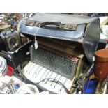 A Pietro Mid XX Century Accordion, with marbelette casing and original damaged carry case.