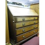 A Late XVIII Century Oak and Mahogany Bureau, with blind fretwork, fitted interior, fall front