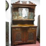 An Early XX Century Walnut Mirror Back Sideboard, with a swan neck pediment, mirror back turned