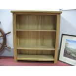 A Light Oak Bookcase, with two adjustable shelves, on square supports.