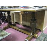 An Oak Refectory Table, with a rectangular top, on cup and cover supports, central stretcher.