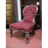 A XIX Century Mahogany Framed Parlour Chair, with spoon back, serpentine front, on turned legs,