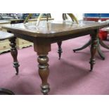 A XIX Century Mahogany Extending Dining Table, with rounded moulded border on turned legs.