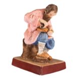 A RUSSIAN PORCELAIN FIGURE OF A SHOEMAKER, GARDNER PORCELAIN FACTORY, MOSCOW, LATE 19TH CENTURY