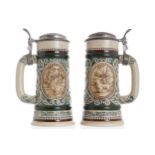 PAIR OF AVON, BRAZIL BEER MUGS each with raised moulded decoration, below a pewter lid 23 cm.