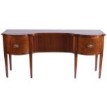 GEORGE III PERIOD MAHOGANY AND BOXWOOD INLAID SIDEBOARD the inverted serpentine fronted top, above a
