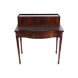 EDWARDIAN PERIOD MAHOGANY WRITING TABLE the rectangular top, with a serpentine breakfront, below a