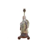 CHINESE POLYCHROME FIGURE STEMMED TABLE LAMP raised on a hardwood scroll base 36 cm. high