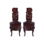 PAIR OF NINETEENTH-CENTURY JAPANESE CEREMONIAL CHAIRS each with a lily carved back and seat,