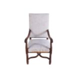 NINETEENTH-CENTURY WALNUT AND UPHOLSTERED LIBRARY CHAIR the raised square panelled upholstered back,