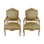 PAIR OF LOUIS XV STYLE CARVED GILT WOOD FRAMED ARMCHAIRS each with a damask armorial shaped back and