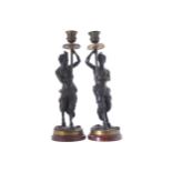 PAIR OF NINETEENTH-CENTURY BRONZE SATYR STEMMED CANDLE STICKS 33 cm. high (2)