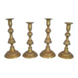 SET OF FOUR GEORGIAN BRASS CANDLESTICKS