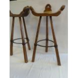 Pair Elm tripod barstools with wrought iron stretchers