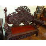 Heavily carved Chinese hardwood bench decorated with birds and foliage,