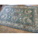 Indian green ground pattern rug (7' x 5')