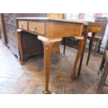 Mid 20thC oak leather inset writing table on ball and claw feet