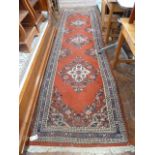 Red ground Persian style runner 11' x 3'