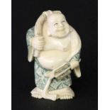 NETSUKE Glücksbuddha mit Rucksack. Fossiles Elfenbein, geschnitzt und bemalt. Signiert. H.5,5cm A