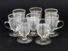 SATZ VON 8 HENKELBECHERN Deutsch um 1900 Farbloses Glas mit Fadendekor. H.9,3cm A SET OF 8 HANDLED