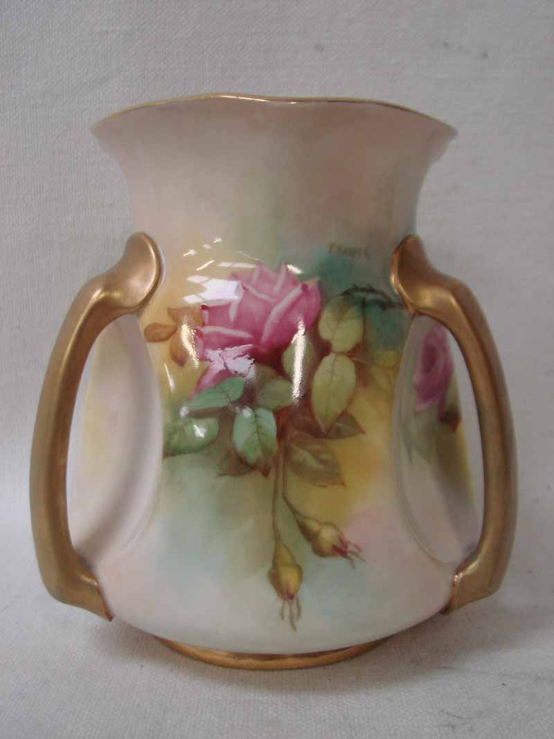 A Royal Worcester three handled vase of dimpled baluster form, painted with panels of pink and