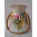 A Royal Worcester three handled vase of dimpled baluster form, painted with panels of pink and